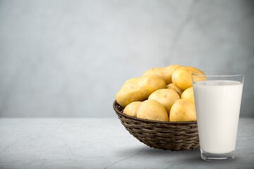 Concept of potato milk on the table with the potato tubers. A new trend in healthy eating. Alternative food.
