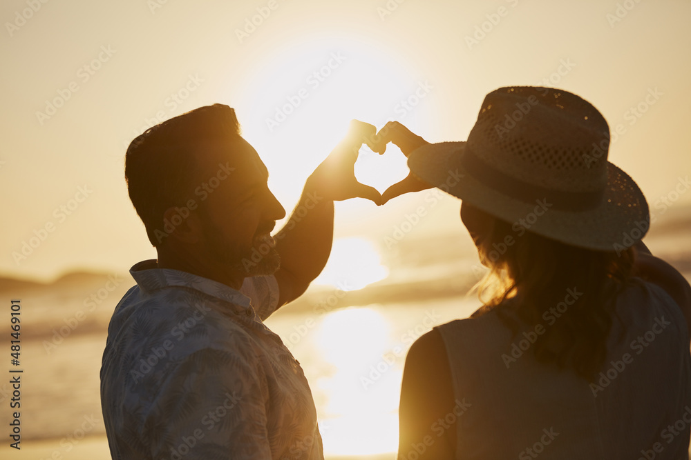 Sticker Love is such a precious gift. Rearview shot of a mature couple spending quality time on the beach.