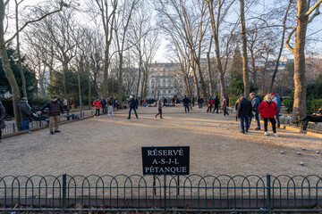 Paris, France - 01 15 2022: The Luxembourg Garden. View of petanque field and petanque players...