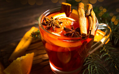 mulled wine in a glass cup on a wooden background