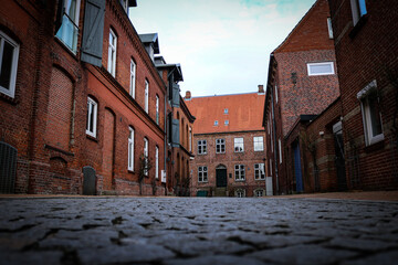 narrow street with old buildings in North Germany 