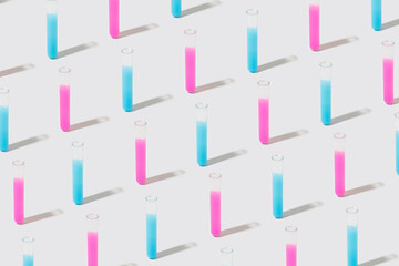 Pattern with test tubes containing blue and pink liquid on a white background. Bio weapon minimal...