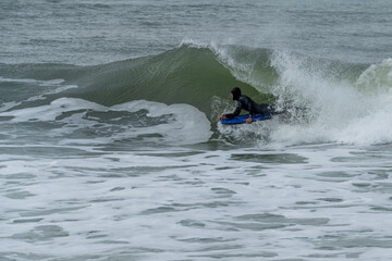 Bodyboarder performing a tube trick