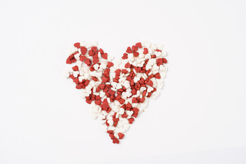 Red and white heart-shaped decoration for baking on white surface