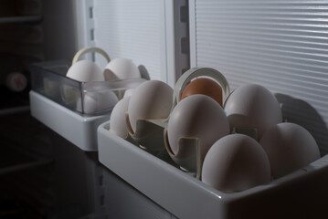 a bunch of chicken eggs in the refrigerator door