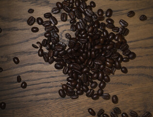 coffee beans sprinkled on a wooden stand