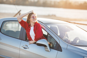 Happy couple traveling together. Man and woman having fun in the trip. Car sharing for young people.