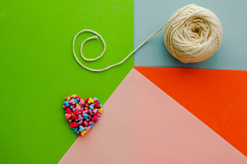 Colorful abstract background with candy hearts and rope