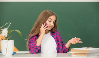 smiling child speak on phone. wearing classy apparel. kid with vintage telephone