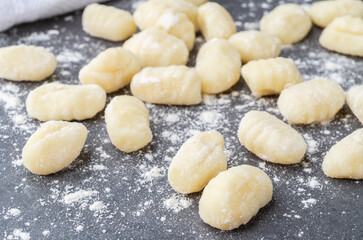 Uncooked italian pasta gnocchi over stone background