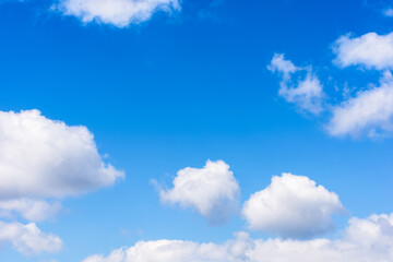 Naklejka na ściany i meble white fluffy clouds on the azure sky. calm weather in spring. beautiful nature background