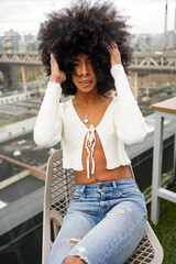 Fototapeta na wymiar USA, New York, Portrait of woman with afro hair in city