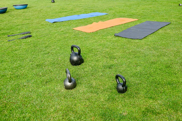 fitness equipment and yoga mats on the grass in the park