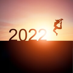 New year concept of 2022. New year's card. Numbers and person on sunset