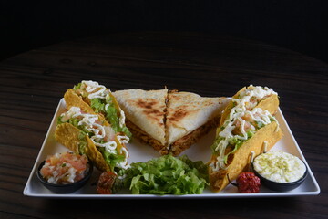 Mexican food, guacamole, nachos, tacos, chili tortillas and quesadillas with salad