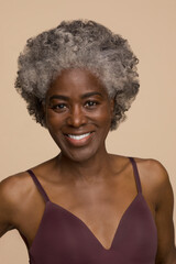 Studio portrait of smiling mature woman