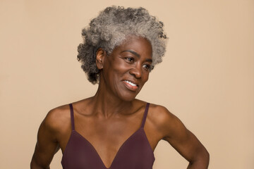 Studio portrait of smiling mature woman