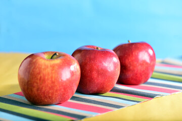 macro photography red apples isolated on colored background with blurs