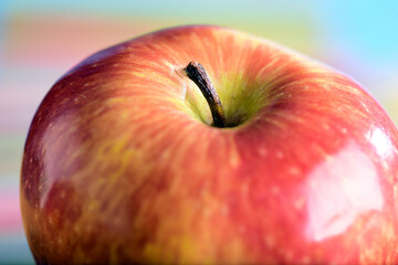 macro photography red apples isolated on colored background with blurs