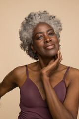 Studio portrait of smiling mature woman
