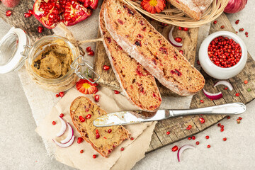 Fresh homemade chicken liver pate or paste in a glass jar with baguette slices on the serving board