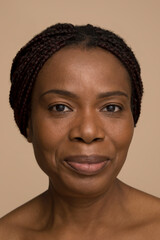 Obraz premium Studio portrait of smiling mature woman with braided hair