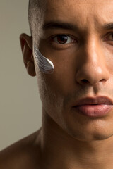 Close-up of man with face cream on cheek