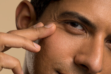 Close-up of man touching face - Powered by Adobe