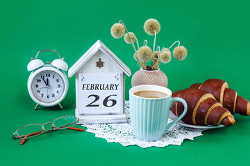 Calendar for February 26: a decorative house with the name of the month in English, the number 26,...