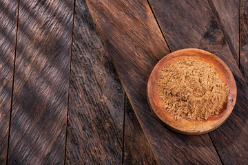 Organic nutmeg powder in the wooden bowl - Myristica