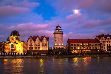 Fishing village in Kaliningrad at night. Stylization of ancient Europe, lighthouse, ancient houses.