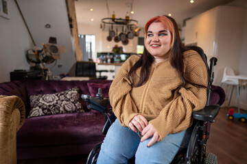 Portrait of smiling woman on wheelchair in living room