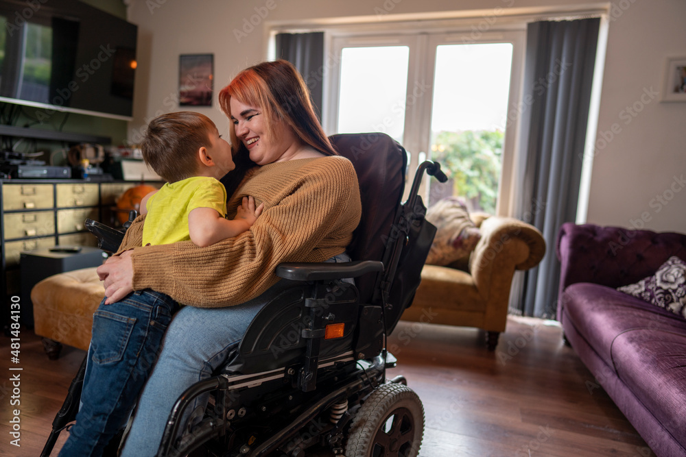 Wall mural woman on wheelchair hugging son