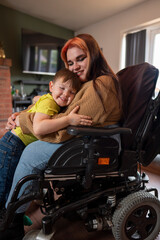 Plakat Woman on wheelchair hugging son