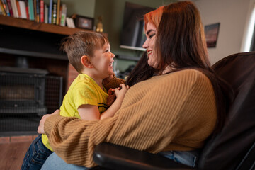 Woman on wheelchair hugging son