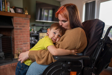 Woman on wheelchair hugging son