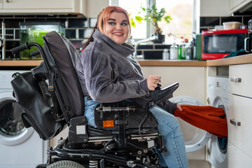 Woman in wheelchair doing laundry