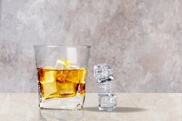 Cleen transparent glasses of whiskey on the table making sun reflection