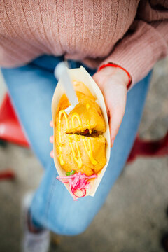 Top View Of Woman Holding Stuffed Potatoes With Onion And Sauce. Street Food. Foodtruck. Focus On Food