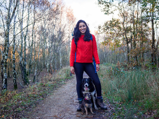 Woman hiking in forest with dogs