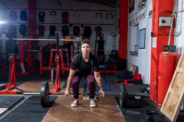 Woman lifting weights at cross training gym