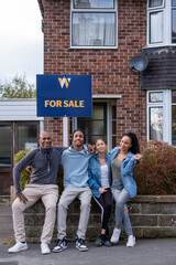 Obraz premium Portrait of family with teenage daughter and son in front of new house