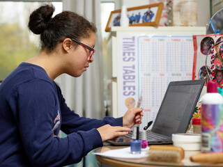 Girl with Down syndrome using laptop