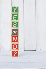 wooden cube, with with word yes or no, on white background