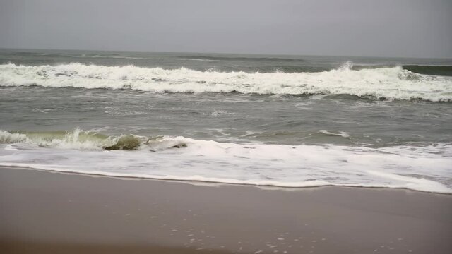 Atlantic ocean, sea strong waves and surf. Sandy wild beach, storm.