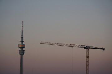 sunset munich with crane and olympic tower
