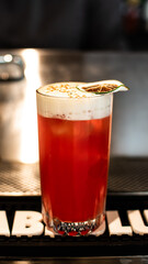 Red lemon cocktail alcoholic drink made by bartender 