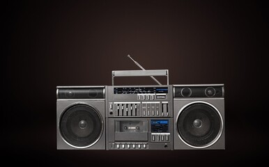 Retro vintage portable stereo cassette recorder from 80s on a background.