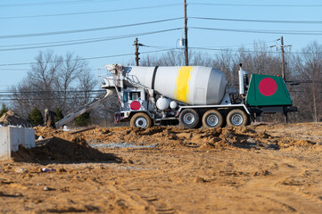 Pouring cement or concrete with a concrete mixer truck, construction site with a reinforced...