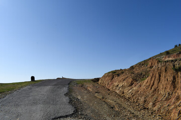 Road turn on top of mountain bright sunny day